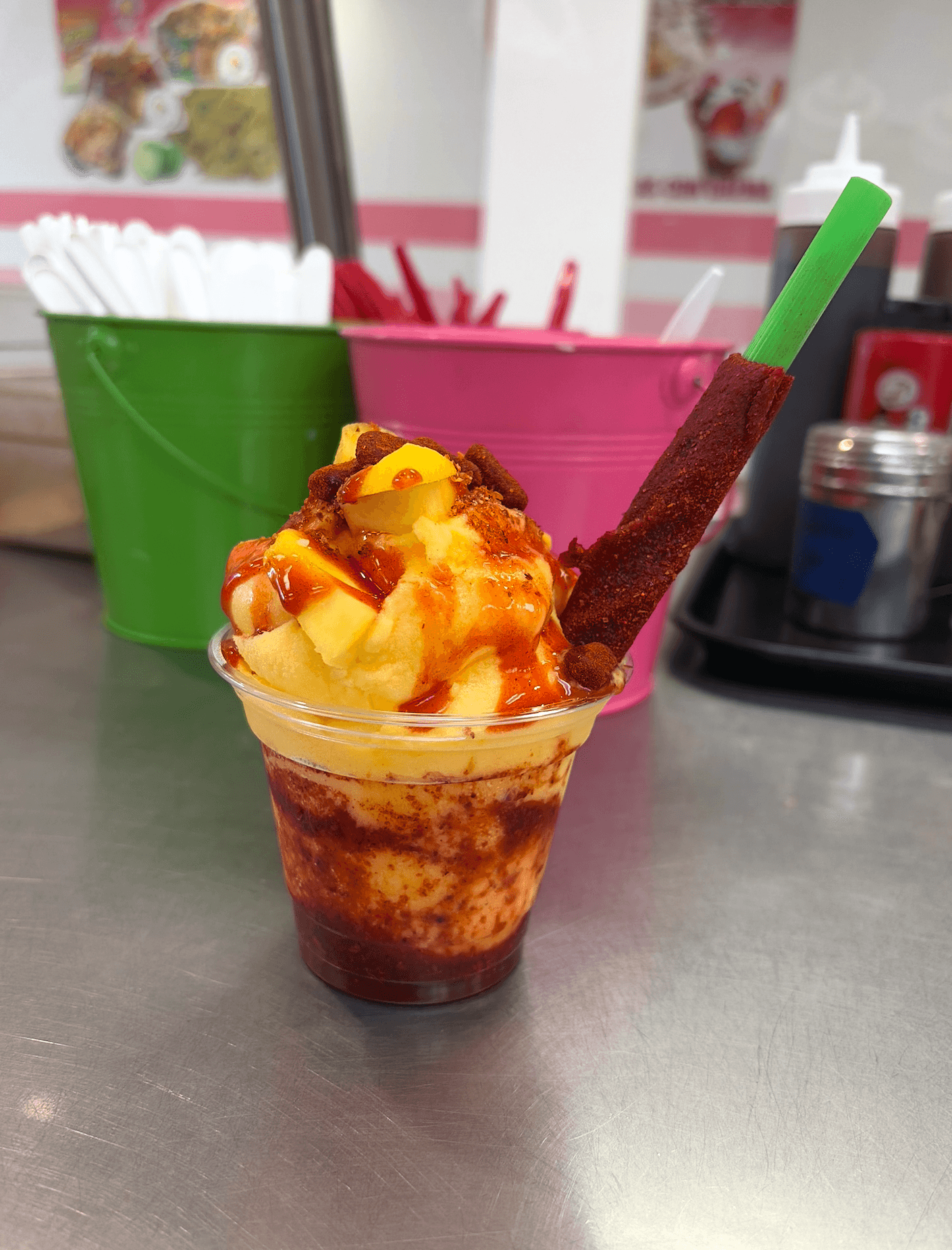 Mangonada with mango sorbet, chamoy, Tajín, fresh mango, and tamarind straw at La Michoacana Tradicional in Pomona, CA