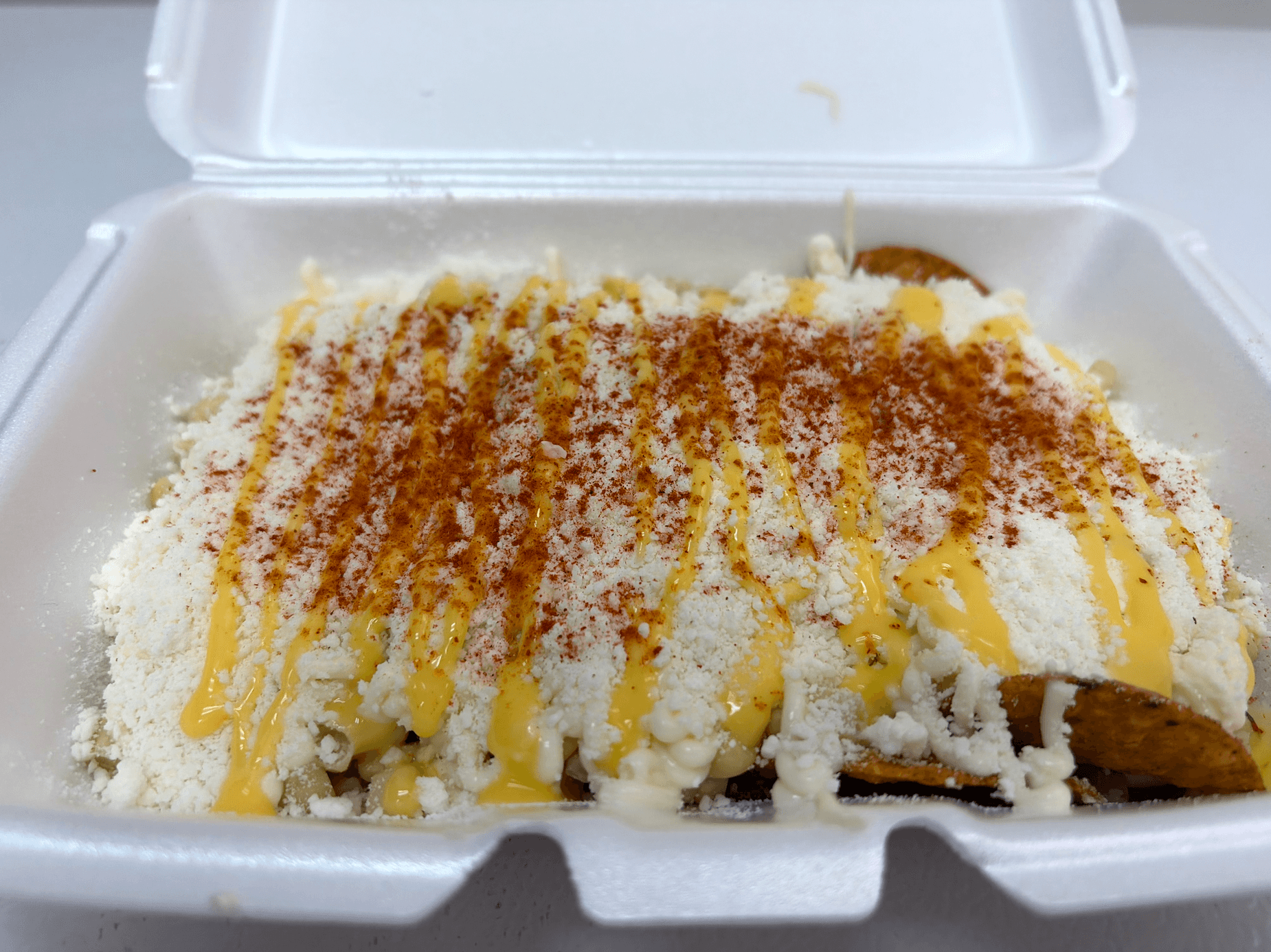 Tostiesquite — Tostitos topped with esquite-style corn, mayo, cotija cheese, lime, and chile at La Michoacana Tradicional in Pomona, CA